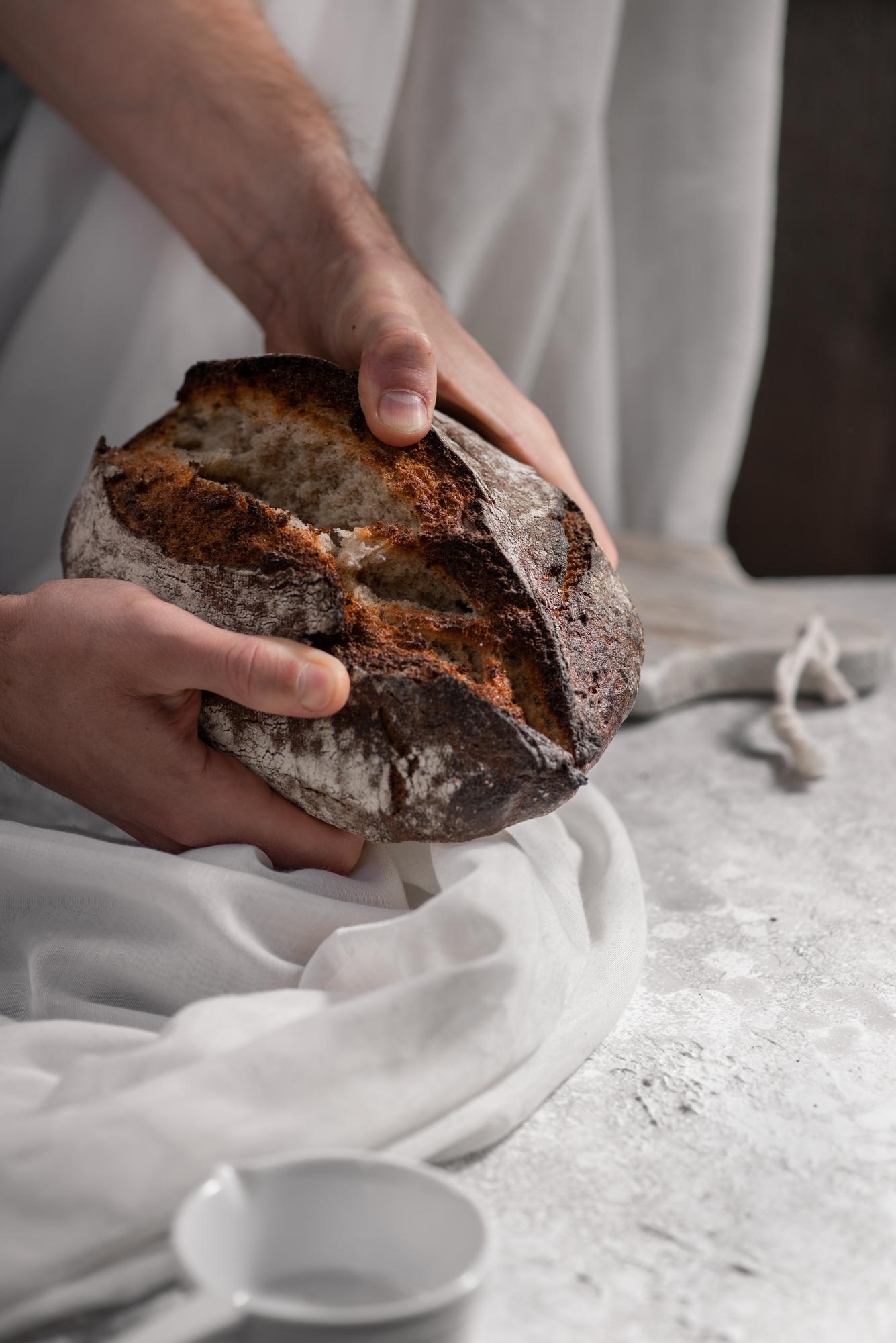 Close-up sourdough loaf scored by hand